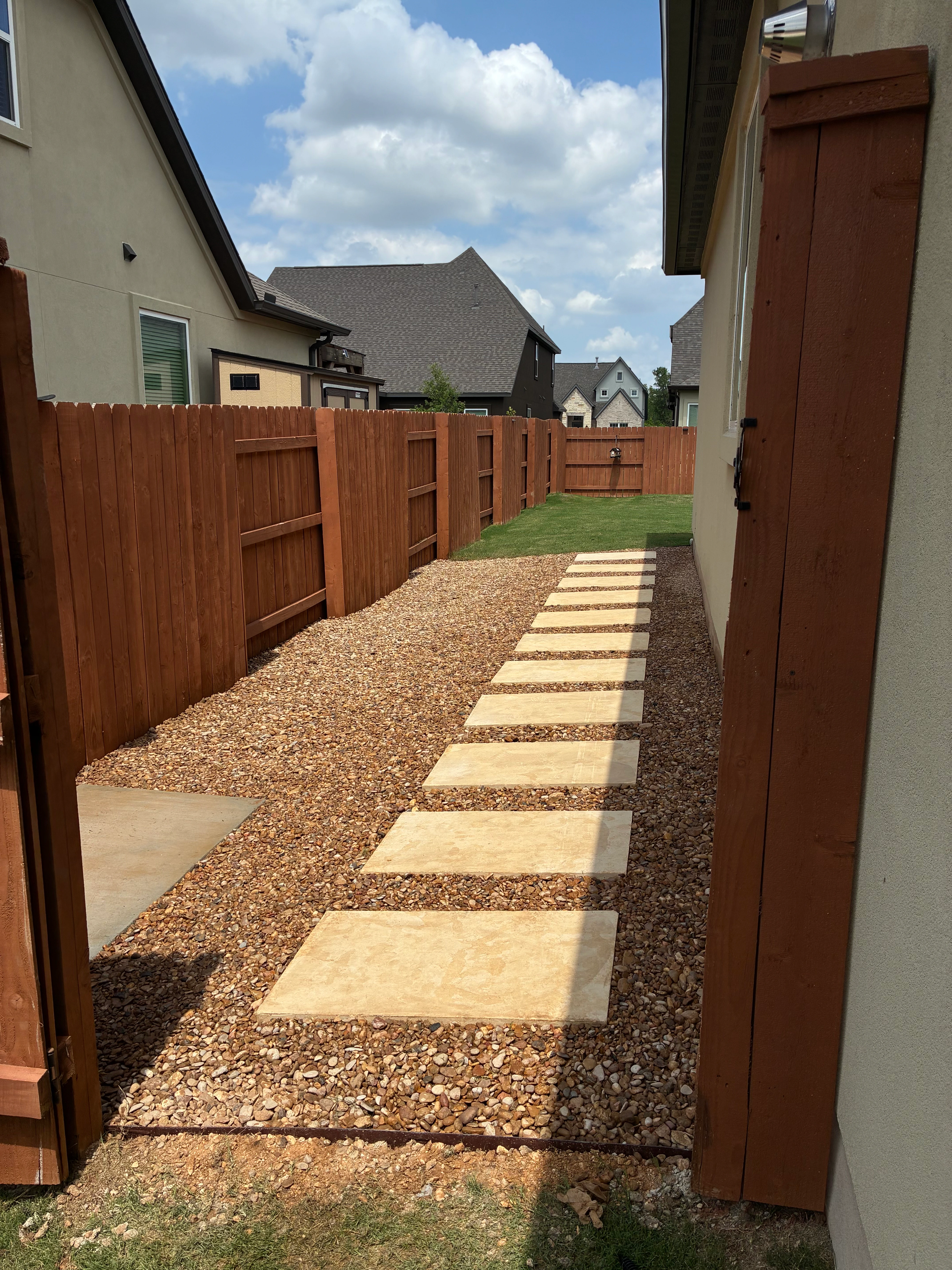Beige stone pathway through backyard